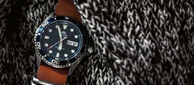 dive watch with brown strap on knitted fabric