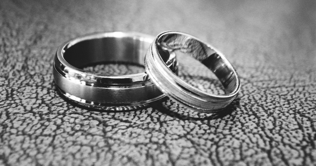 closeup of two silver rings on table black and white image