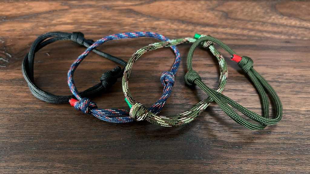 closeup of 4 rope bracelets in blue green and black
