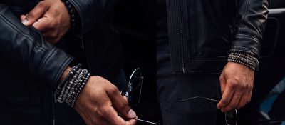 closeup of man in leather jacket wearing bracelets