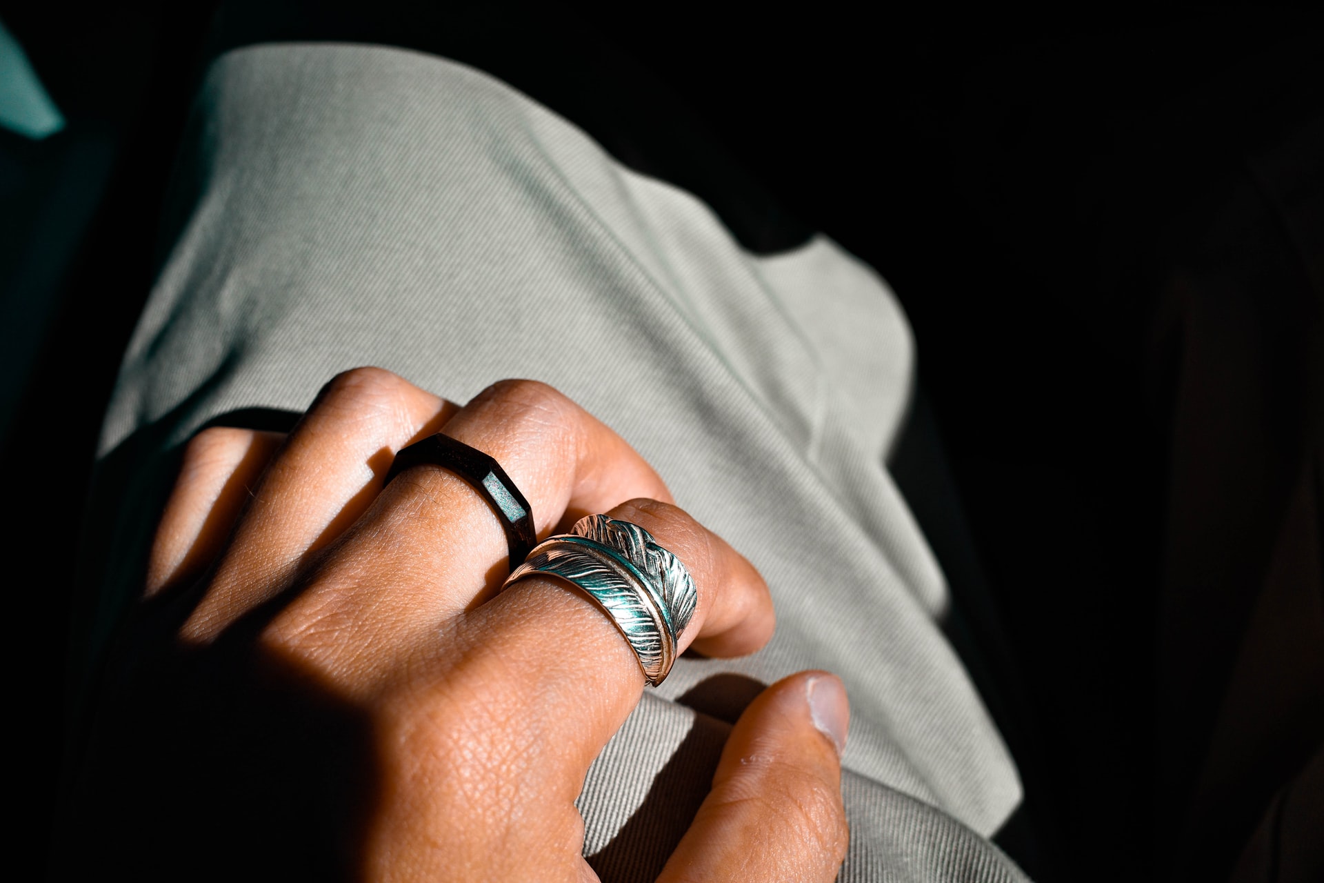 silver ring on persons ring finger