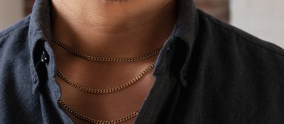closeup of man's neck wearing chains layered