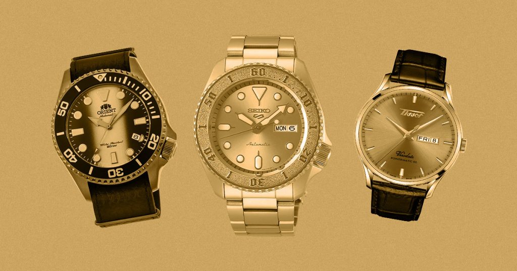 stylized flatlay of watches on gold background